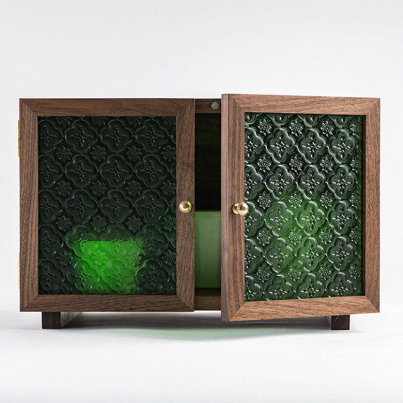 Elegant walnut storage cabinet with decorative green glass doors