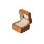 Hand holding a natural solid wood ring box
