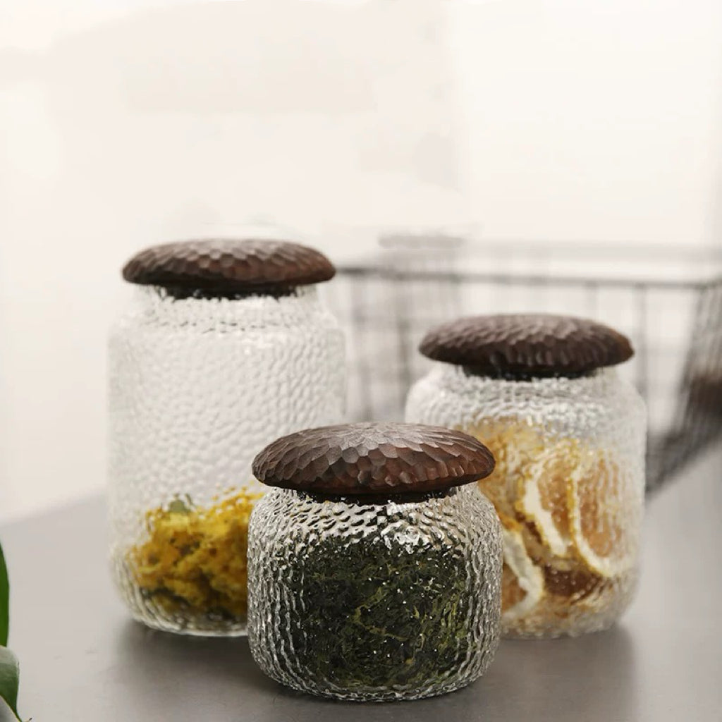 Haven Black Walnut Hammered Seal Glass Container on kitchen counter