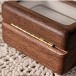 Minimalist solid wood ring box on table surface