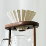 Minimalist walnut pour-over coffee stand on countertop