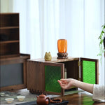 Mossaire walnut cabinet featuring green embossed glass doors