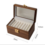 Neatly stacked bangles inside minimalist black walnut box