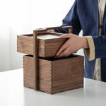 Tea storage box with handle opened to display compartments