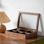 Top-down view of jewelry compartments inside wooden box