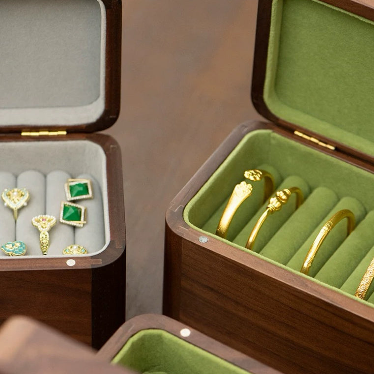 Walnut box open with a single patterned glass bangle